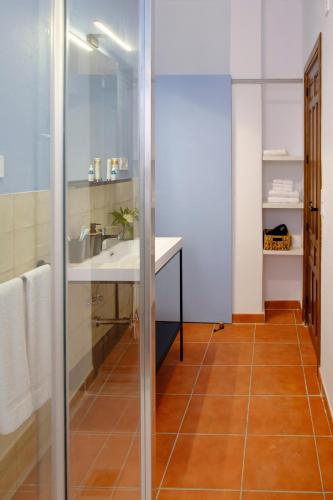 a bathroom with a sink and a mirror at El Fresquedal in Alozaina
