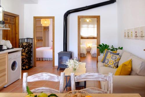 a living room with a couch and a stove at El Fresquedal in Alozaina
