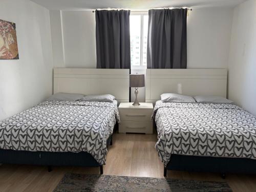 a bedroom with two beds and a window at Ocean Reserve STR-01045 in Sunny Isles Beach