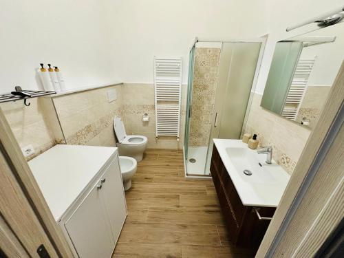 a bathroom with a toilet and a sink and a shower at Casa Lucia in Marta