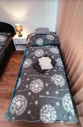 a bedroom with two beds with dandelions on the blanket at NiKi in Patince