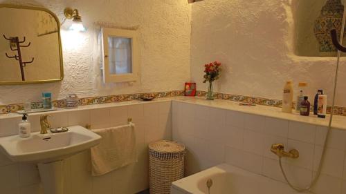 a bathroom with a sink and a toilet and a mirror at Ca na Pereta in Sencelles