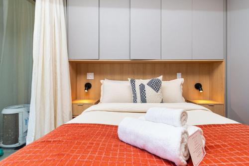a bedroom with a large bed with towels on it at GRU Residence by Housi in Guarulhos