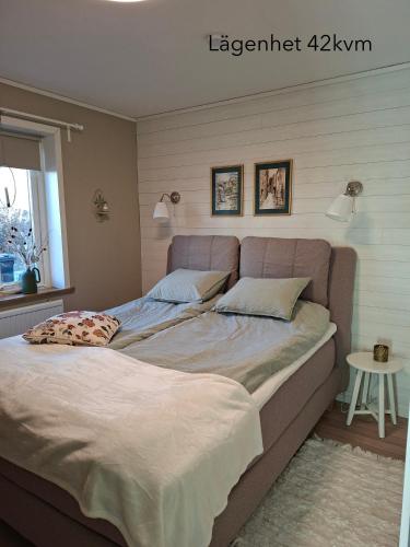 a bedroom with a large bed and a window at Ellas Brygga in Karlskrona