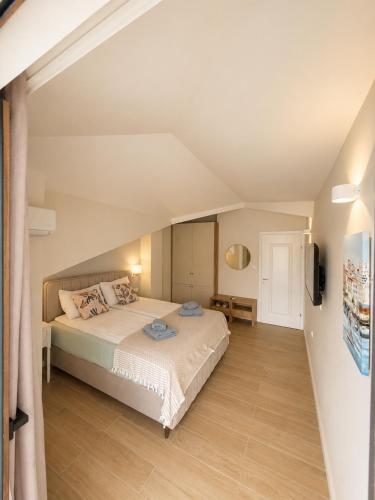 a bedroom with a large bed in a attic at Villa Lucija in Ohrid