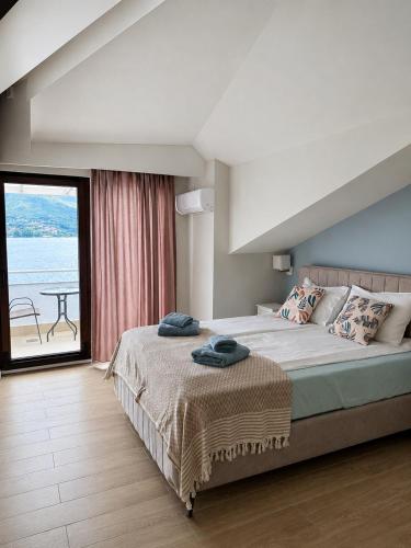 a bedroom with a bed with a view of the ocean at Villa Lucija in Ohrid