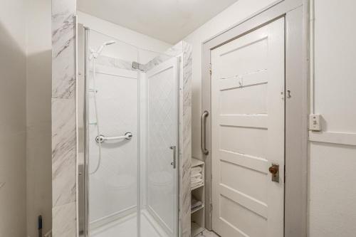 a shower with a glass door in a bathroom at Walkable 3-Unit Hub: 8 Mi to Micron Technology! in Phoenix