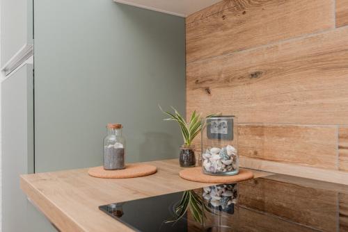 a kitchen with a counter with a sink and wooden wall at Charming Open Space in Costa Smeralda in Olbia