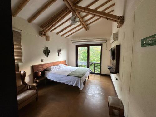 a bedroom with a bed and a tv in a room at Finca Panaca Jaguey 7 in Quimbaya