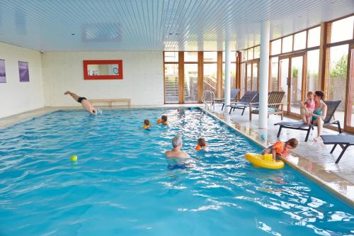 a group of children playing in a swimming pool at Domaine Du Val in Grand-Laviers