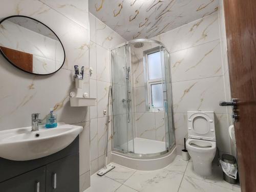a bathroom with a shower and a sink and a toilet at Jurassic Coast Gateway Exmouth Escape in Exmouth