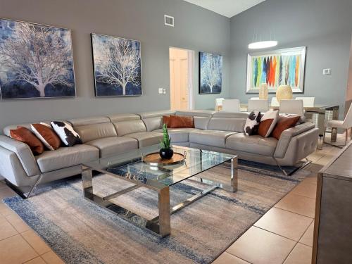 a living room with a couch and a table at Amazing Star Wars Villa - Theater, Full Arcade & Private Pool, 5BR Near Disney in Orlando