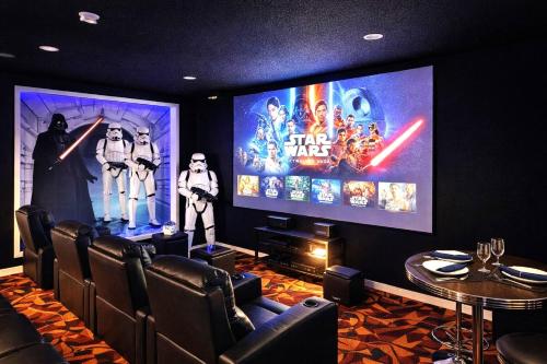 a room with a movie theater with a large screen at Amazing Star Wars Villa - Theater, Full Arcade & Private Pool, 5BR Near Disney in Orlando