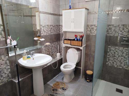 a bathroom with a toilet and a sink and a shower at Tawfik in Midoun