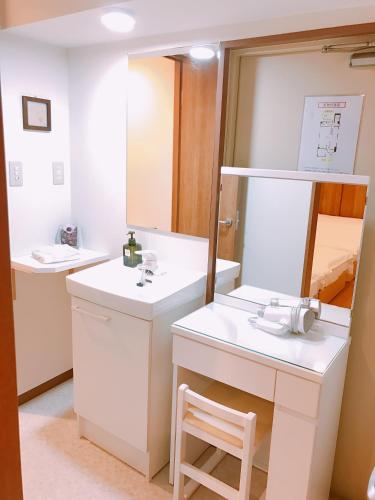 a bathroom with a sink and a mirror at Sarangbang in Kyoto