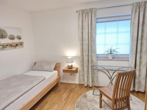 a bedroom with a bed and a desk and a window at Modern & Gemütlich XL in Linden