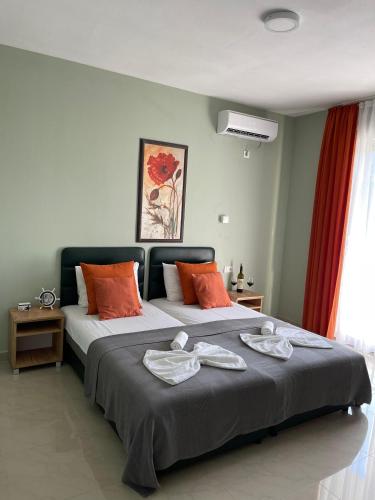 a bedroom with a large bed with towels on it at Hotel Solaris in Čanj