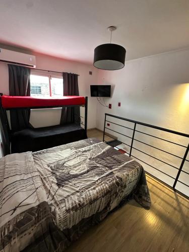 a bedroom with a bed and a chair in it at Mini casita a in Rosario