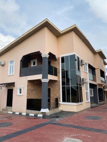 a large brick building with a large window at sky 7 hotel & apartment in Akure