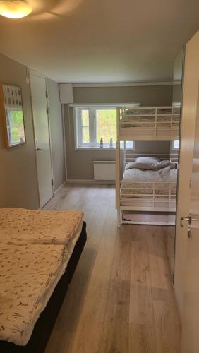 a bedroom with two bunk beds and a window at Lägenhet i Strömstad in Strömstad