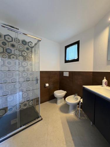 a bathroom with a shower and a toilet and a sink at Cav Casa Brunella in Castiglione della Pescaia