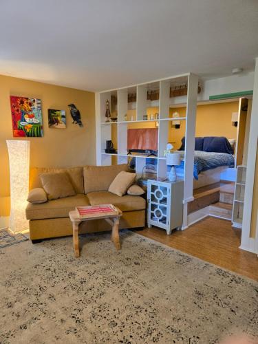 a living room with a couch and a bed at Cozy Sanctuary in Saltspring Island