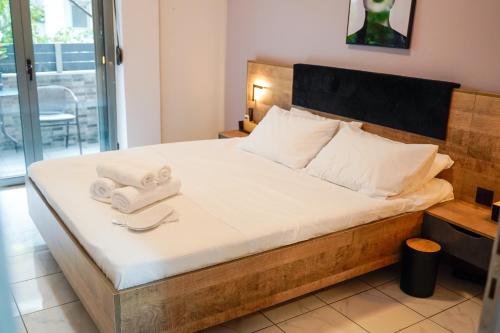 a bedroom with a bed with towels on it at Stellar Island Home-Kos in Kos