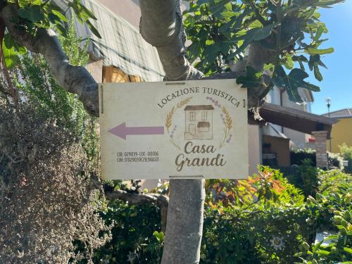 a sign for a casa grandita on a tree at Casa Grandi in Ca Tiepolo