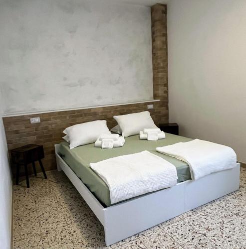 a bedroom with a bed with two white pillows at Casa Grandi in Ca Tiepolo