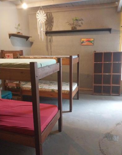 a room with a table and a bench in a room at Pedramarca - Ferrugem in Garopaba