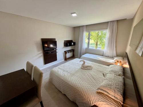 a bedroom with a bed with a swan on it at Suite Pinamar 09 in Pinamar