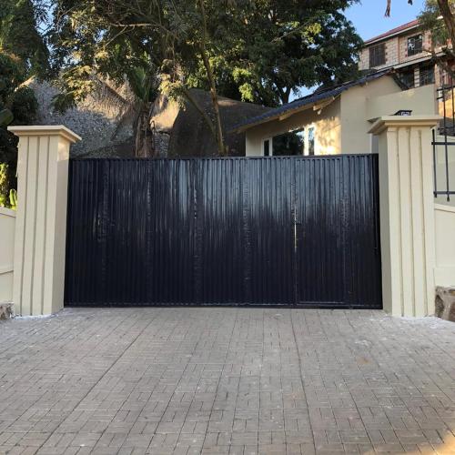 a black gate in front of a house at Capri Hills in Mwanza