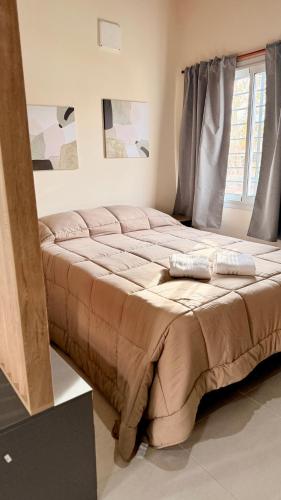 a large bed in a room with a window at Apart Zona Paula in San Juan