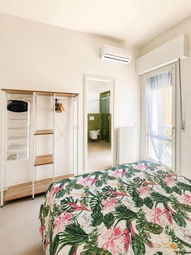 a bedroom with a bed with a floral bedspread at Al Carlino Verona in Verona