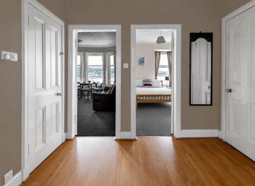 a hallway with two doors and a room with a bedroom at Lady Mary Sea View in Rothesay