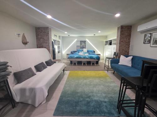 a living room with a couch and a bed at The Dream house in Tomaš