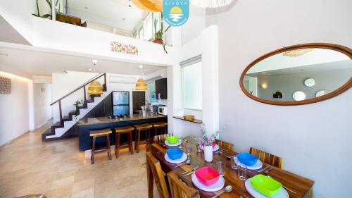 a dining room with a table and a mirror at Terra 12 Penthouse Private Shallow Pool & Beach Access in Nuevo Vallarta