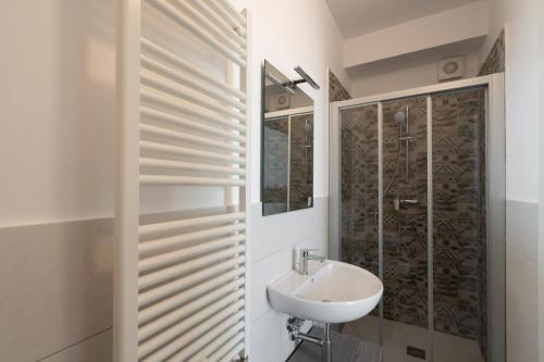 a bathroom with a sink and a shower at Sumus Smart Residence in Porto SantʼElpidio