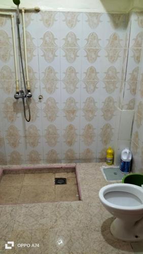 a bathroom with a shower and a toilet at شقق دبي مفروشة in Tarfaya