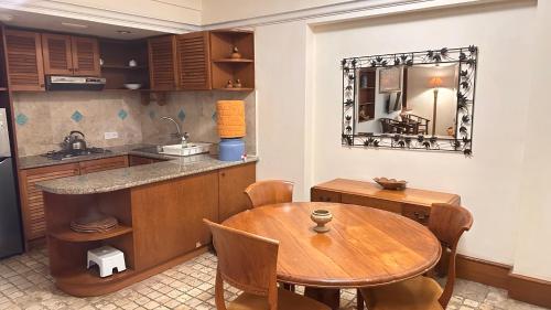 a kitchen with a wooden table and a dining room at Nattaya at the Jayakarta Bali in Seminyak