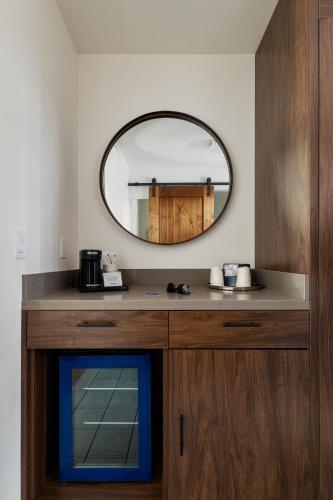 a bathroom with a mirror and a sink at La Playa Inn Santa Barbara in Santa Barbara