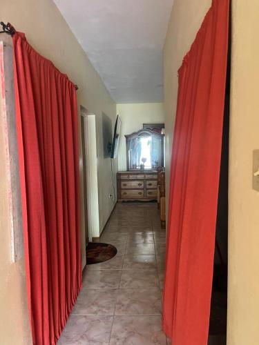 a hallway with red curtains in a room at Driftwood Suite in Runaway Bay