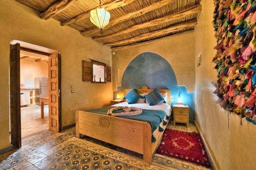 a bedroom with a bed in a room at Villa Nouran Beldi in Essaouira
