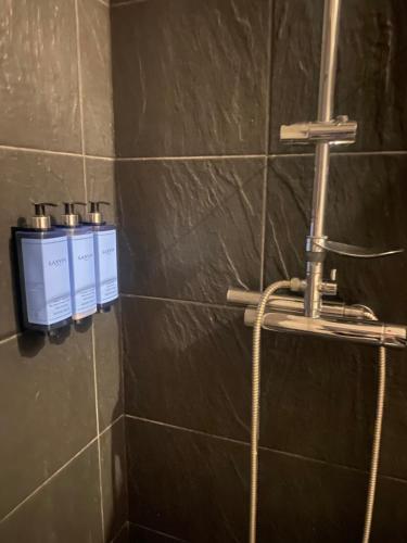 a shower with a hose in a bathroom at Casa da Âncora in Viana do Castelo