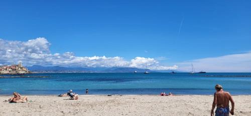 a group of people on a beach near the water at Cap SOLEIL in Antibes