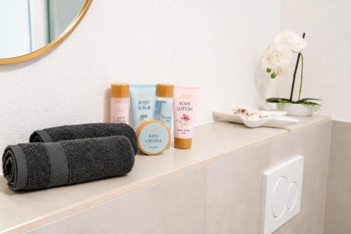 a shelf with three products on a bathroom counter at ILA vacation home Memmingen in Memmingen