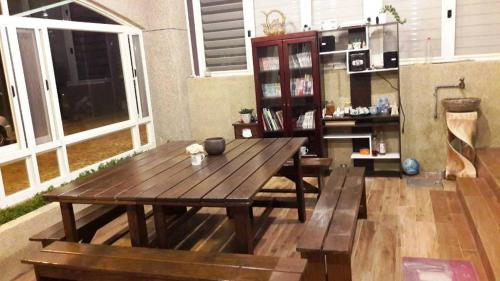 a living room with a wooden table and a bench at 微旅行Micro Travel in Guanshan