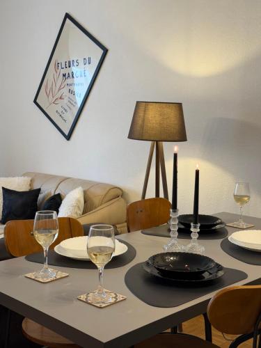 a table with two candles and plates and wine glasses at Premium Apartment in Peje