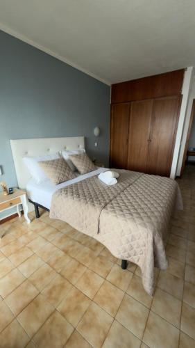 a bedroom with a large bed in a room at Rocha Paradise Apartment in Portimão