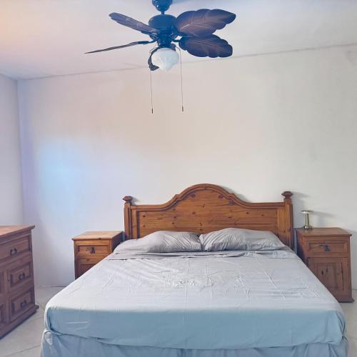 a bedroom with a bed with a ceiling fan at Casa el palmar in Guaymas